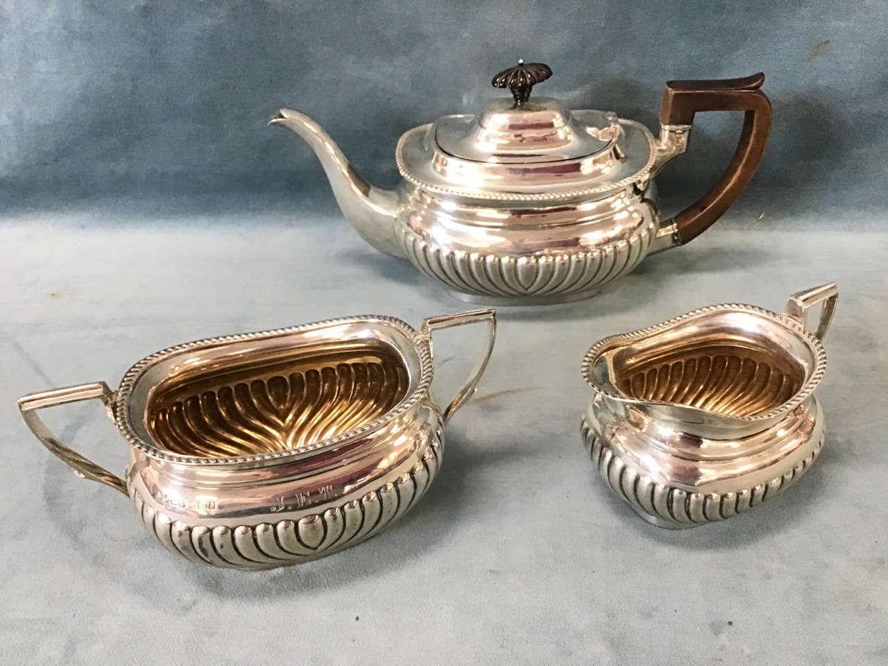 A Victorian three-piece hallmarked silver teaset with oval bulbous gadrooned bodies and angled