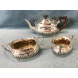 A Victorian three-piece hallmarked silver teaset with oval bulbous gadrooned bodies and angled