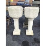 A pair of octagonal garden urns on columns, the pots with oakleaf & acorn, fircone and ivy leaf cast
