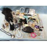 A collection of miscellaneous bangles and costume jewellery including beads, hair pieces, watches,