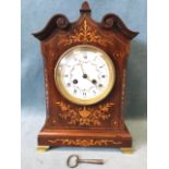 An Edwardian mahogany mantle clock inlaied with boxwood leaf, ribbon andf urn decoration and