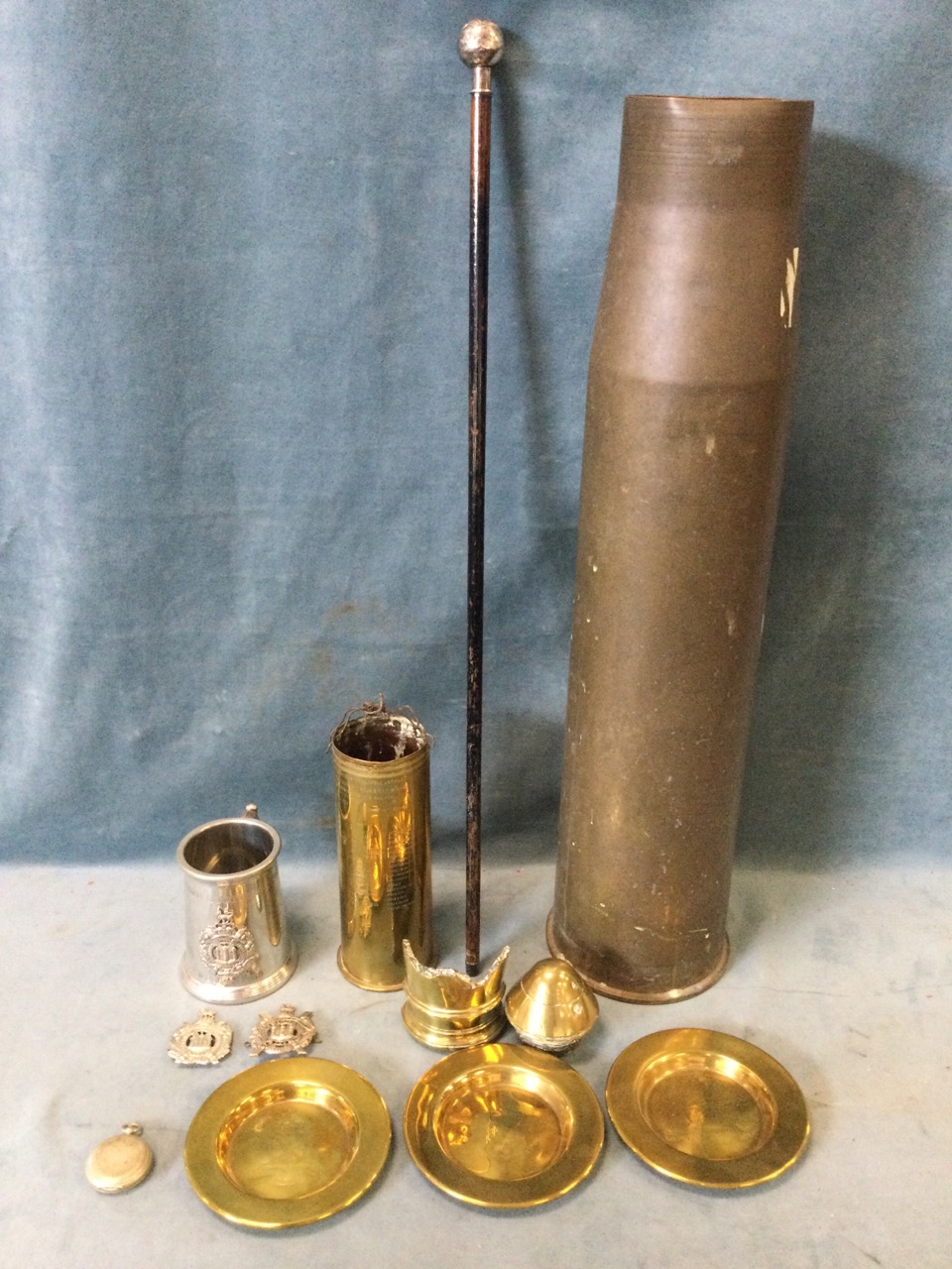 A collection of militaria - a 4.5 caliber shell casing; a shell casing engraved for Captain KM