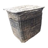 A large cane basket with hinged lid and handles to sides. (35in x 23.5in x 29.5in)