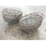 Ten oval potato baskets with galvanised mesh on iron frames, having handholes to ends. (23.5in) (