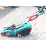 A Bosch electric garden rotary mower, model Rotak 43 Ergoflex, with long cable and grassbox.