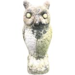A composition stone owl, the bird cast on log with painted eyes. (16in)