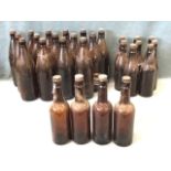 26 brown glass home-brew type bottles with black vulcanite screw stoppers. (26)