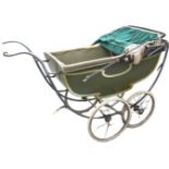 A C20th Marmet pram with spoked wheels and upholstered wood body with concertina hood and fringed