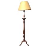 A mahogany standard lamp with shade, the turned tapering fluted column with circular tray beneath