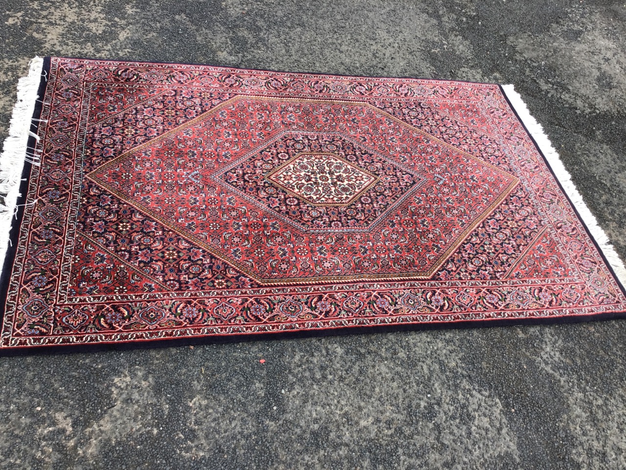 A Kashan style rug woven with multi-floral field centering on a diamond shaped medallion, the frieze - Image 2 of 3