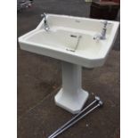A Shanks washbasin with moulded soap dishes and original chrome taps, the cut-corner basin on