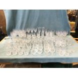 A large quantity of drinking glasses, mainly sets of Edinburgh Crystal cut glass - tumblers, wine