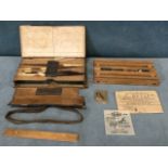 A Victorian leather angling wallet containing hooks, quill floats, a wood line spool with sliding