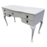 A painted bowfronted mahogany dressing table with moulded top above a central frieze drawer