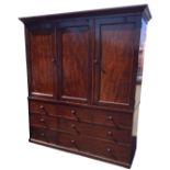 A nineteenth century mahogany press by Holland & Sons, with moulded ogee cornice above panelled