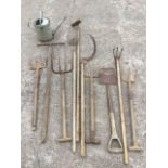 Miscellaneous old garden tools - forks, a spade, rakes, hoes, a scythe, a galvanised watering can,