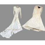 An ivory silk satin wedding dress, with beaded neckline, short train and tulle underskirt; and a
