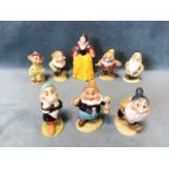 A Beswick set of Snow White and the Seven Dwarfs, the figurines all gilt named & numbered. (8)