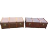 A near pair of travel trunks with brass mounts and rounded wood slats on canvas lined ground -