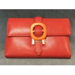 A red leather Hermès trifold wallet, the fitted interior with card holders, pockets, pouch, etc.,