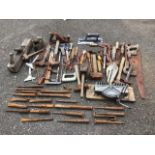 Miscellaneous tools including trowels, jemmies, saws, hammers, chisels, planes, a mitre block, a