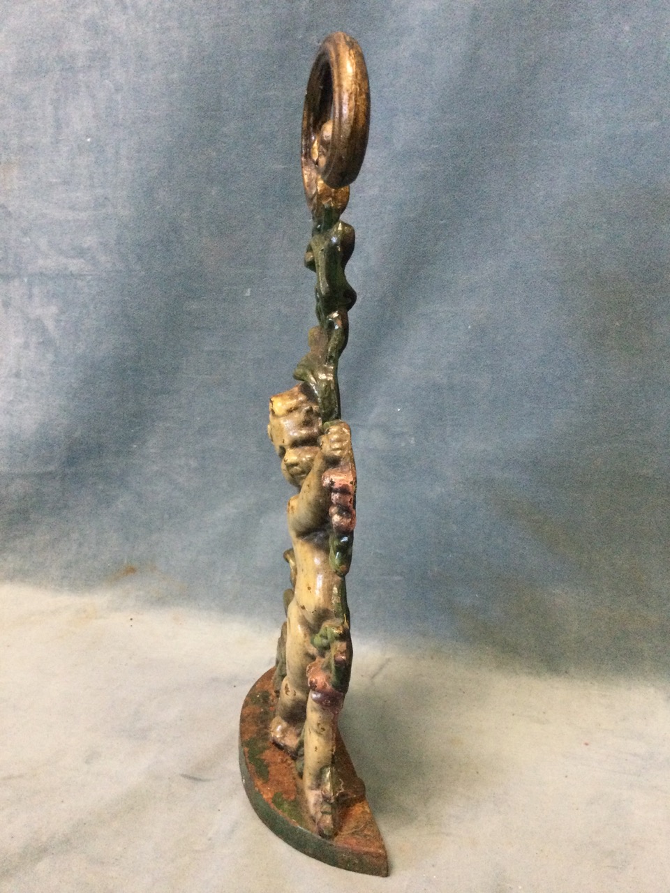 A Victorian cast iron doorstop modelled as a cherub with vines on crescent shaped base, with - Image 2 of 3