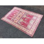 An oriental chenille wall hanging having central panel decorated with the Kaaba, Mecca, and an