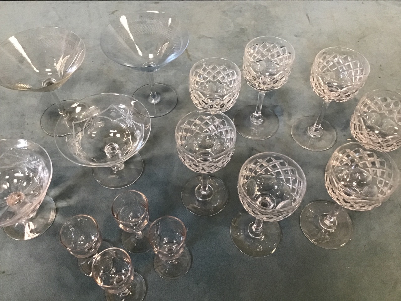 A set of seven wine glasses with facet cut bowls on hexagonal columns; a pair of deco style gimlet
