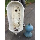 A cast iron wall fountain with arched back and rounded basin; and a Victorian cast iron ball