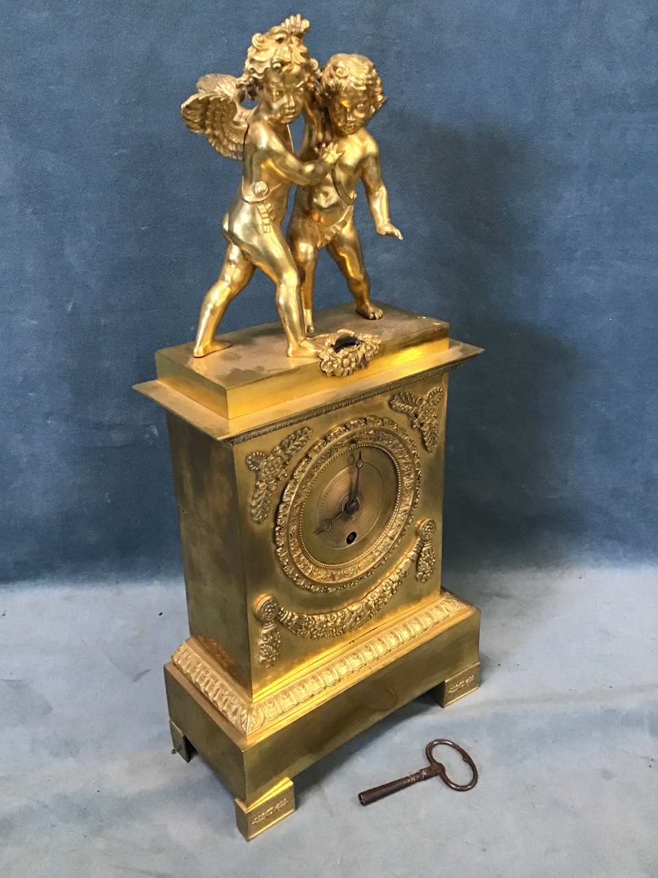 An early 19th century French ormolu clock, surmounted by a pair of startled putti, the egg & dart - Image 3 of 3