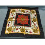 A Hermès of Paris silk scarf, having buckle & strap borders, and lionshead medallions framed by