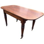 A Victorian mahogany dining table, the rectangular rounded top with ribbed edge above a frieze