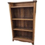 An arts & crafts Gustav Stickley style oak bookcase with moulded egg-and-dart cornice above four