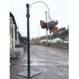 A painted tubular metal stand on square base, having branch hung with seven hanging baskets. (8)