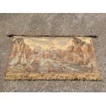 A machine woven tapestry wall hanging, depicting a 17th century Dutch waterfront, the suspension