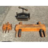 A 19th century heavy cast iron and brass bookbinders press on stand; and two boxwood binders