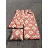 A pair of lined and interlined red cotton curtains, printed with floral panels on red ground,