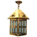 An arts & crafts style hanging brass hall lantern with square vented canopy above a mottled glass