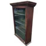 A Victorian mahogany glass fronted gun cabinet, the dentil cornice above a glazed door enclosing
