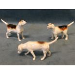 A trio of small Beswick hunting hounds, stamped on the underside. (3)