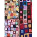 Four knitted wool patchwork blankets with woven and crochetwork square panels joined by colourful
