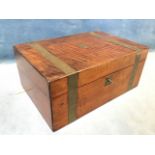 A Victorian mahogany writing box with brass banding and escutcheons, having interior with gilt