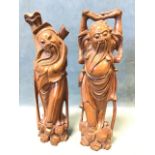 A pair of Japanese carved hardwood bearded figures with inlaid eyes, each with stick-type supports