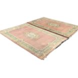 A pair of Kayam Chinese hand knotted wool Aubusson pattern rugs, the central floral medallions