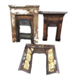 Three rusty old Victorian cast iron fireplaces - one an insert with egg & dart moulding and floral