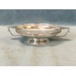 A silver twin handled bonbon dish, the pierced galleried rim framing a shallow bowl with two