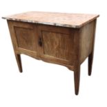 An Edwardian oak washstand with marble slab top above panelled cupboard doors, raised on square