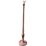A C20th mahogany standard lamp with fluted tapering column above a baluster carved with harebells