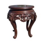 A Japanese circular carved wood stool, the top with a greek key border and moulded edge above a