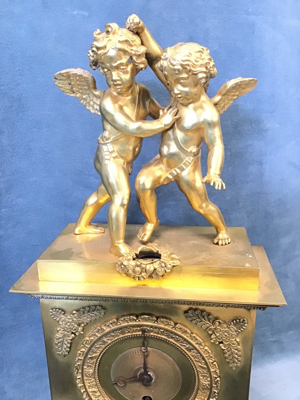 An early 19th century French ormolu clock, surmounted by a pair of startled putti, the egg & dart - Image 2 of 3